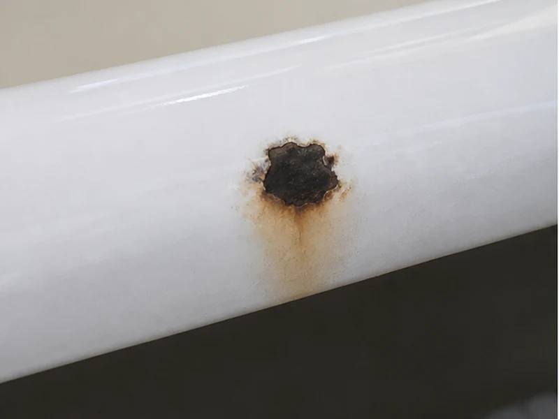 Chipped front rim exposing rust on a cast-iron tub in a Rockridge Oakland home before repair